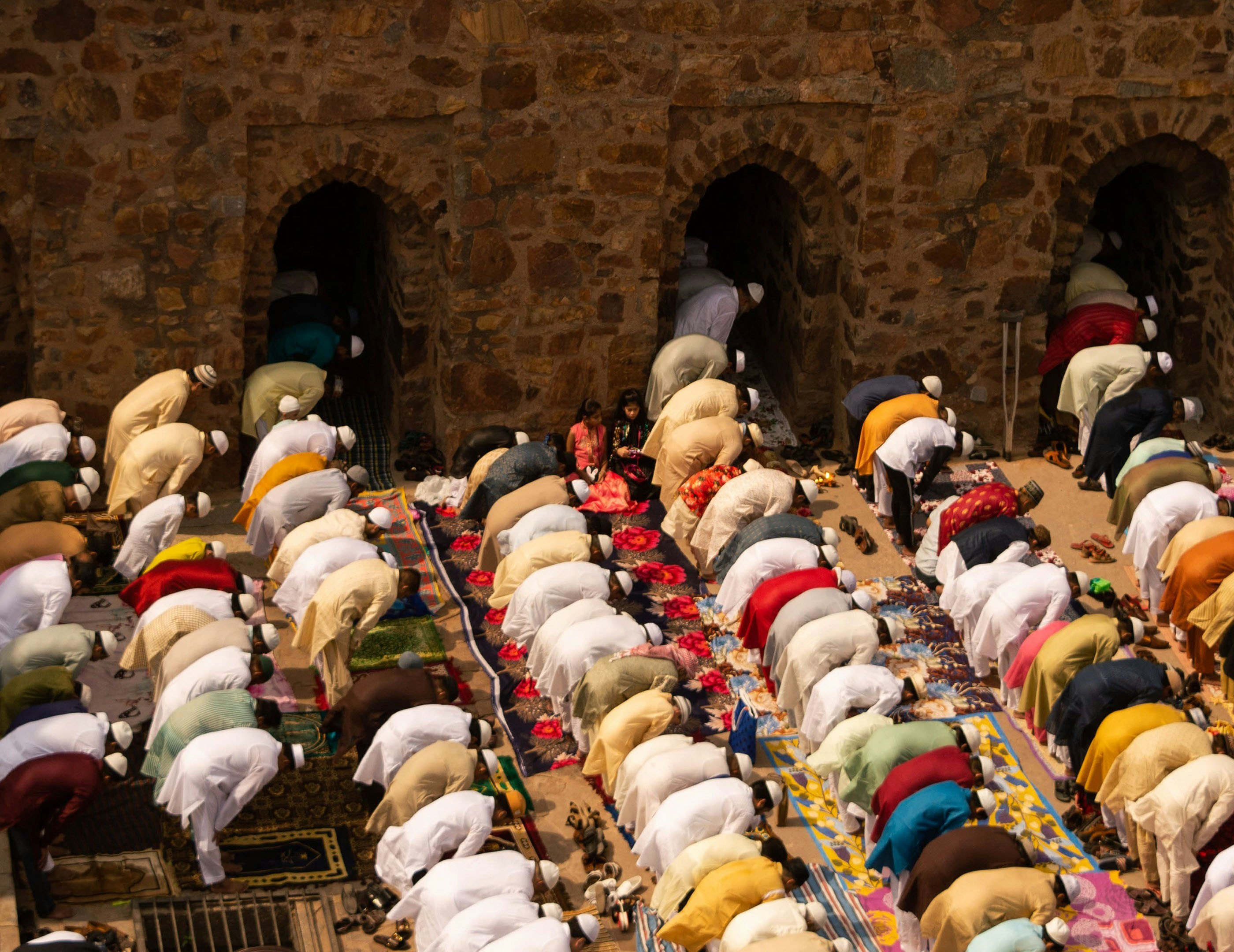 A group of men bowing in prayer