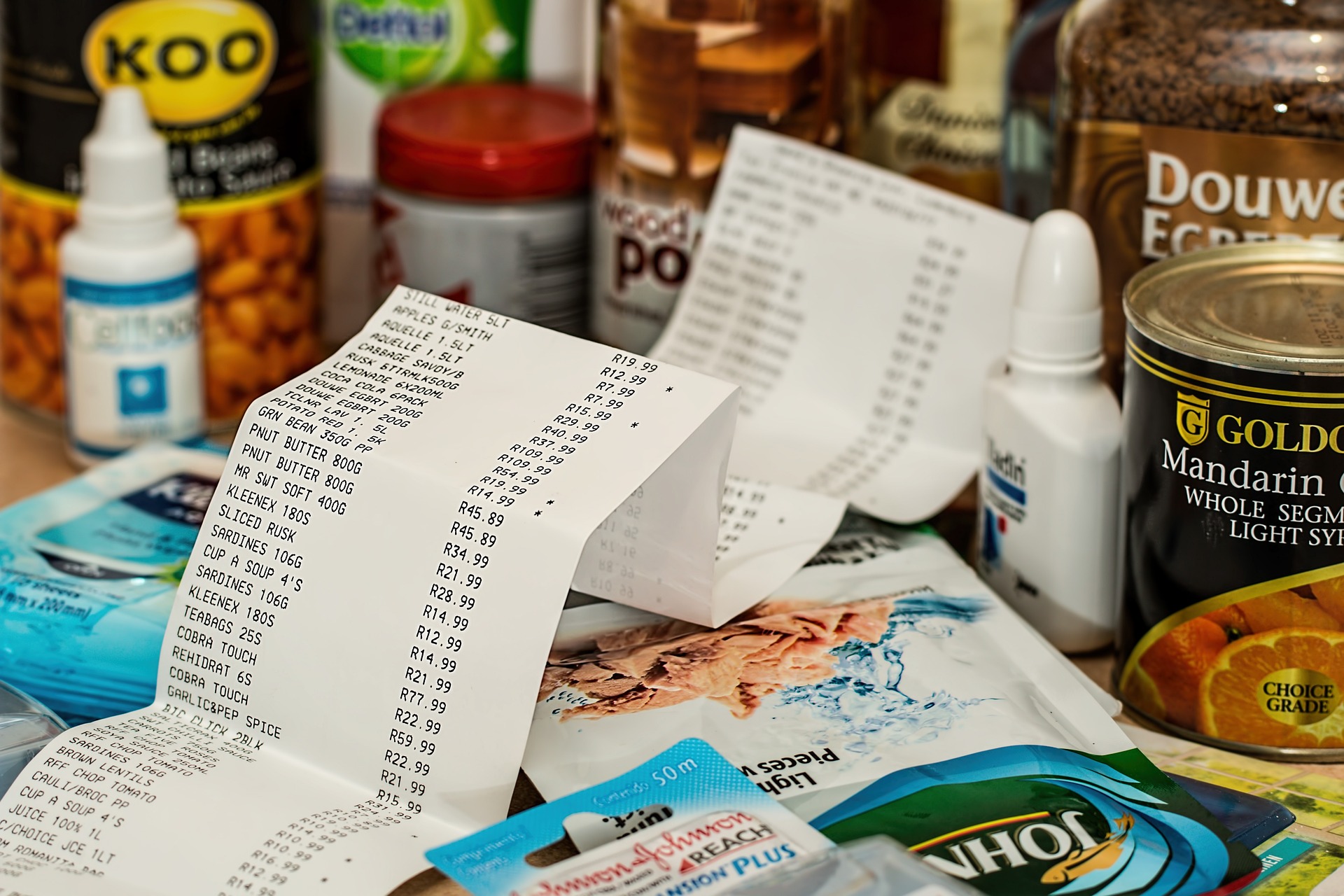 A supermarket receipt on a table with household items