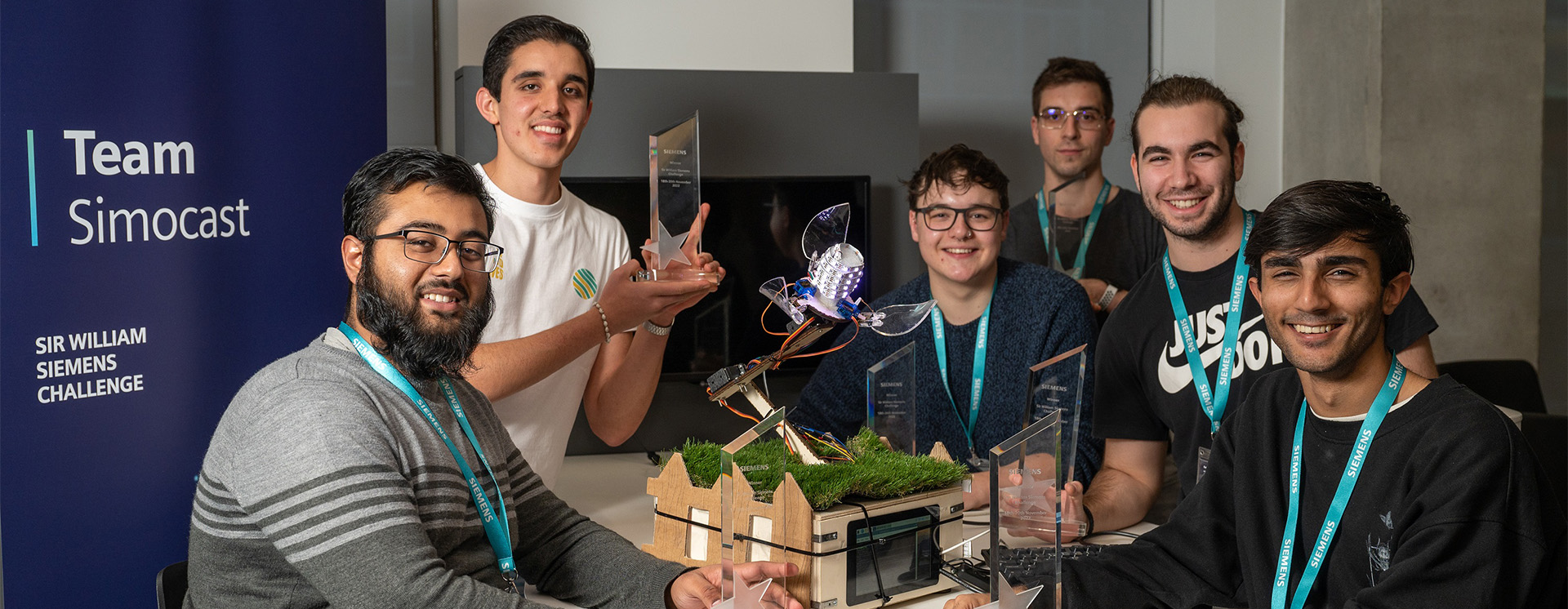 Group of University of Birmingham Engineering students holding their hackathon prize trophy