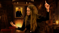 Woman wearing black clothing doing sign language alongside Shakespeare play