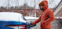 Man charging car in the snow