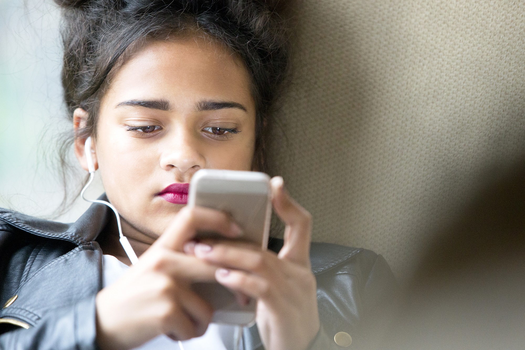 Teenage girl looking at a mobile phone. 