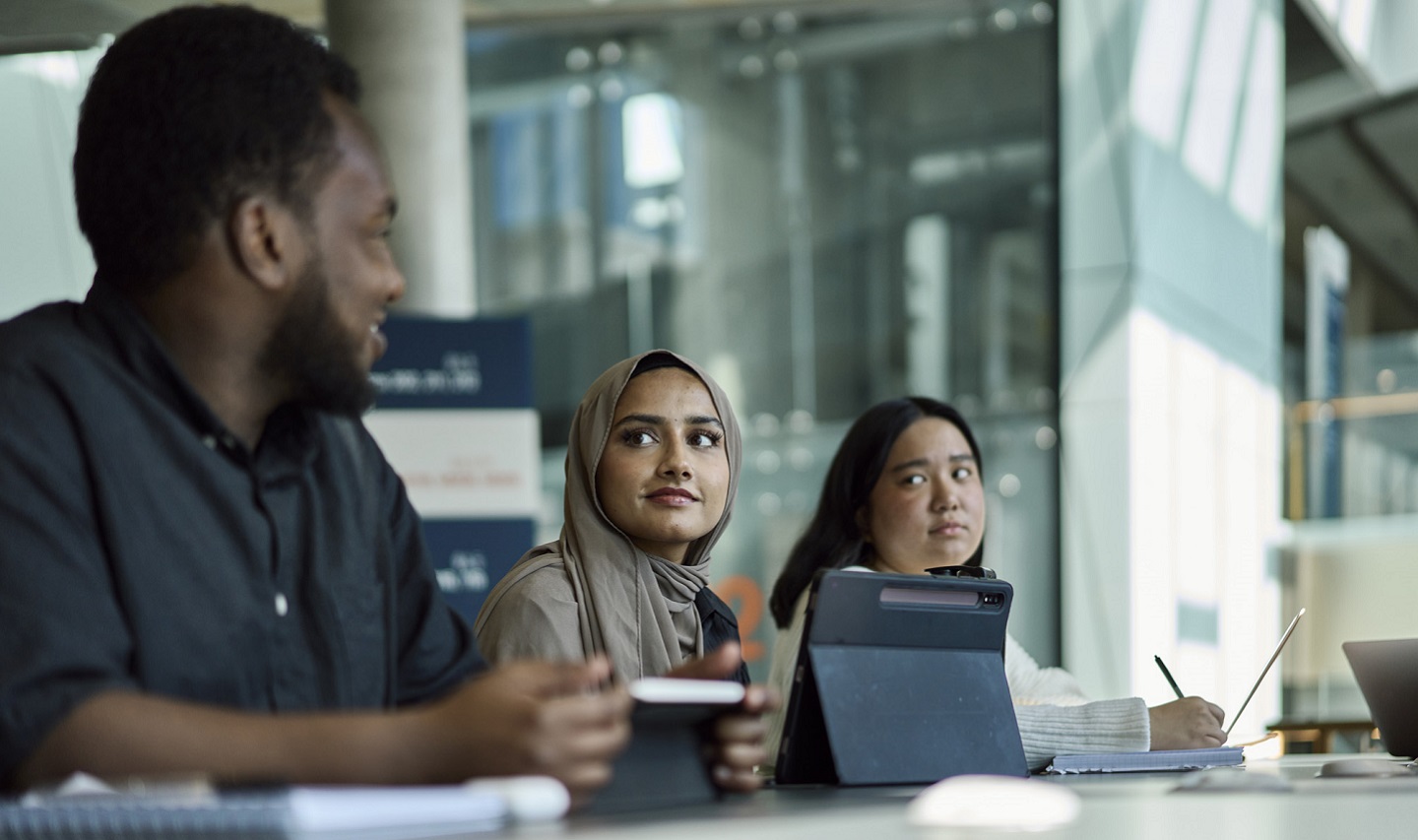 Three students using laptops