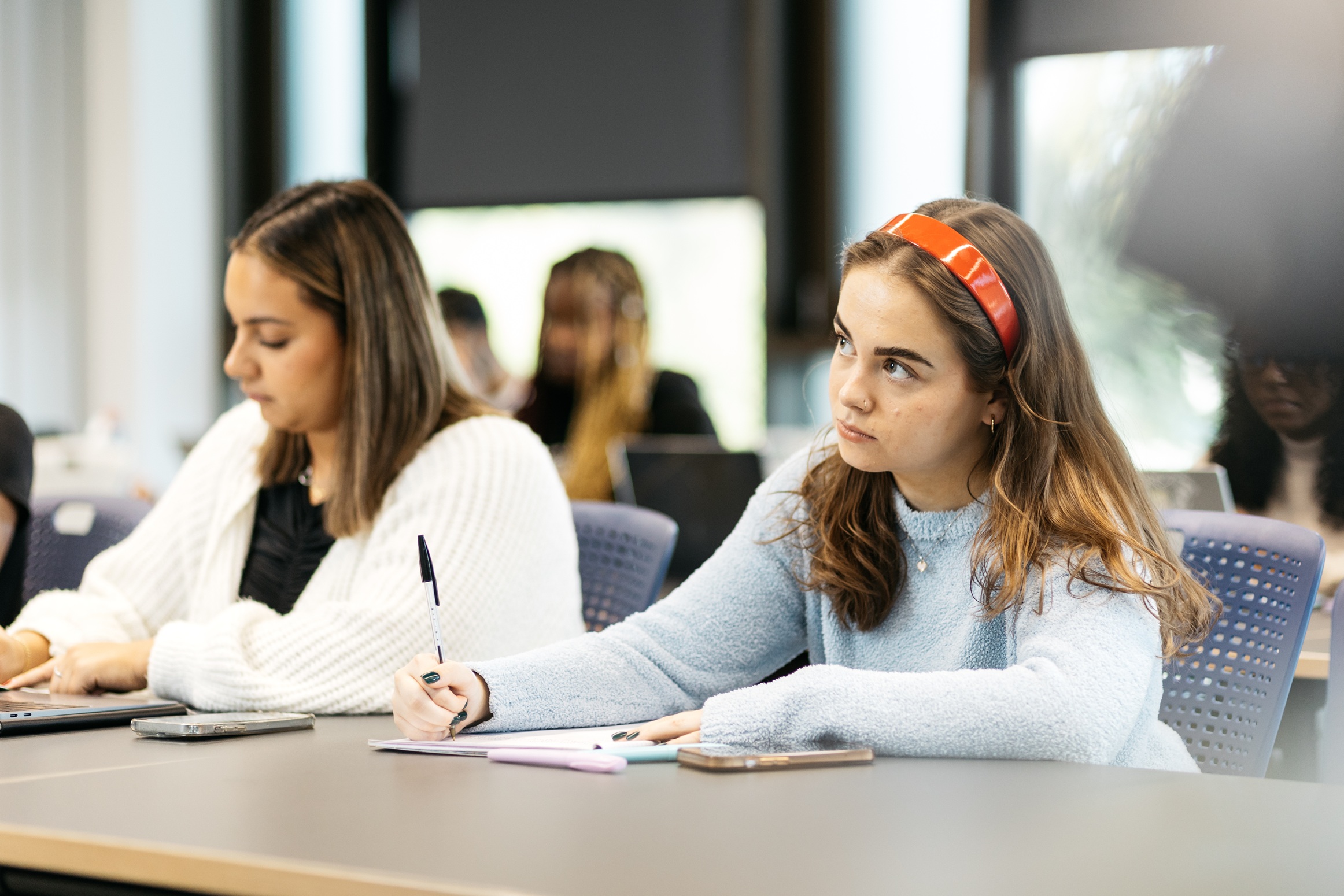 Students writing in a classroom