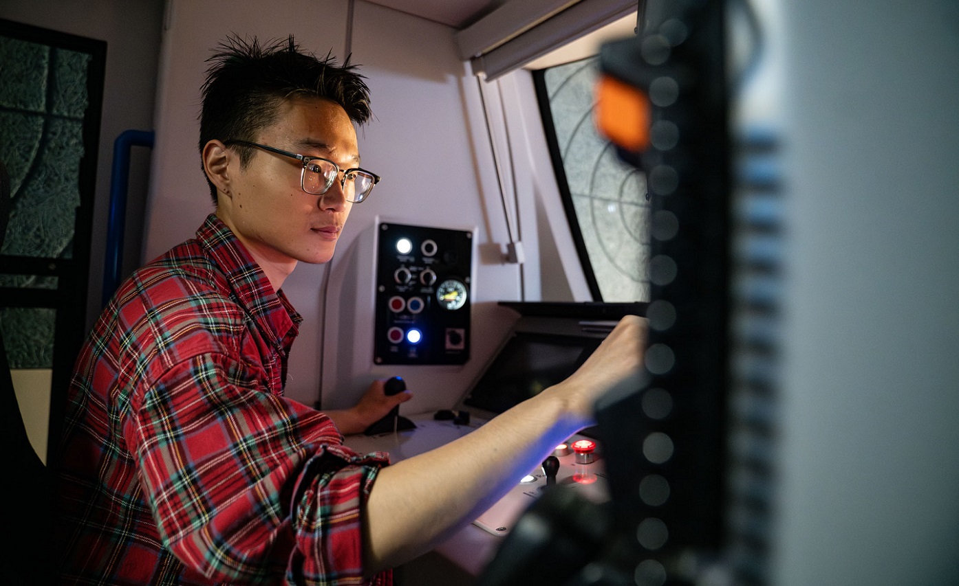 Person operating control panel in train simulator