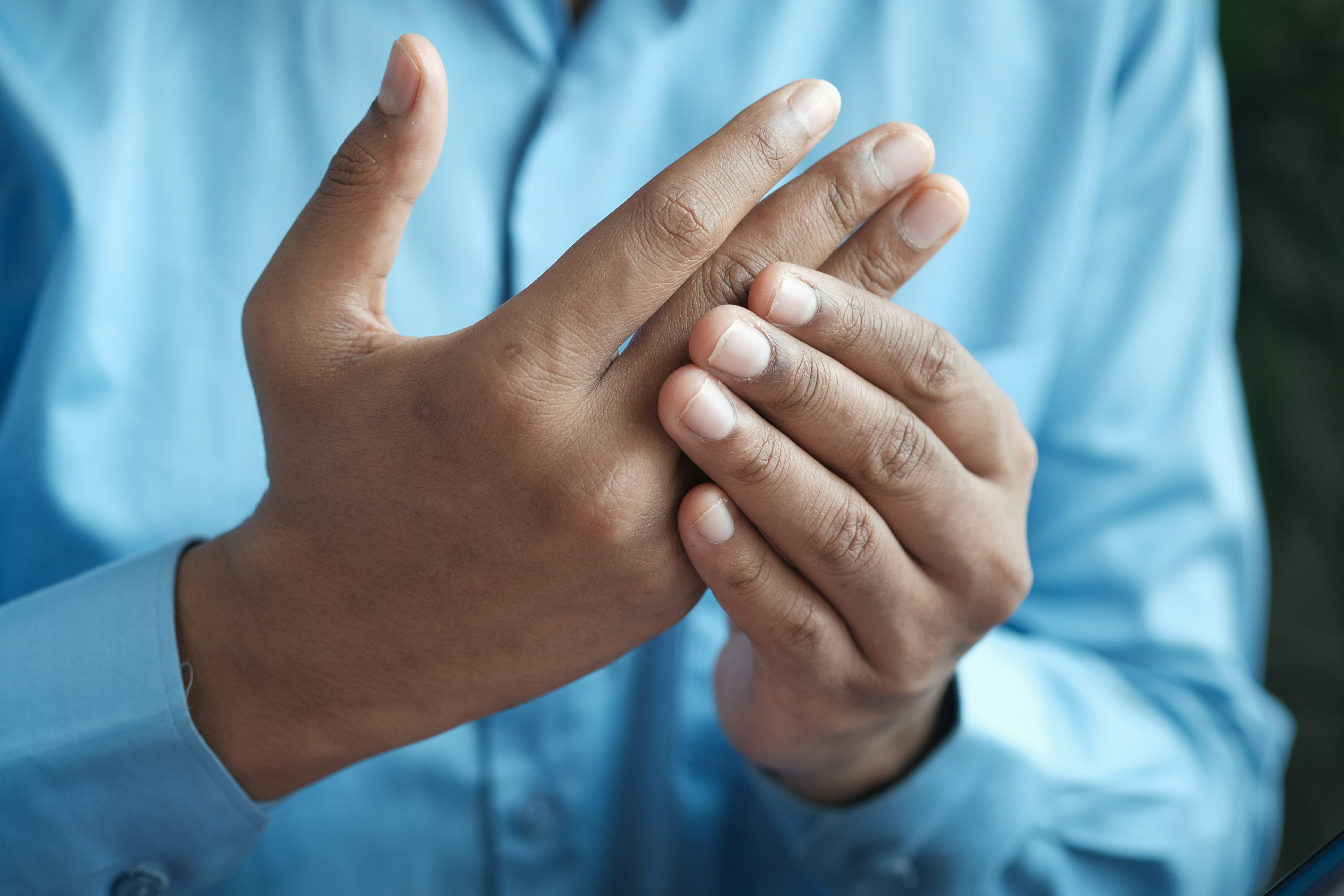 A person rubbing their painful hands