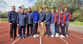 Oliver Dustin with University of Birmingham Sport staff at the University’s athletics track.