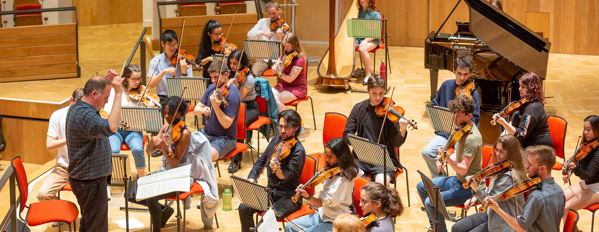 An orchestra practicing performing in the Bramall Music building 