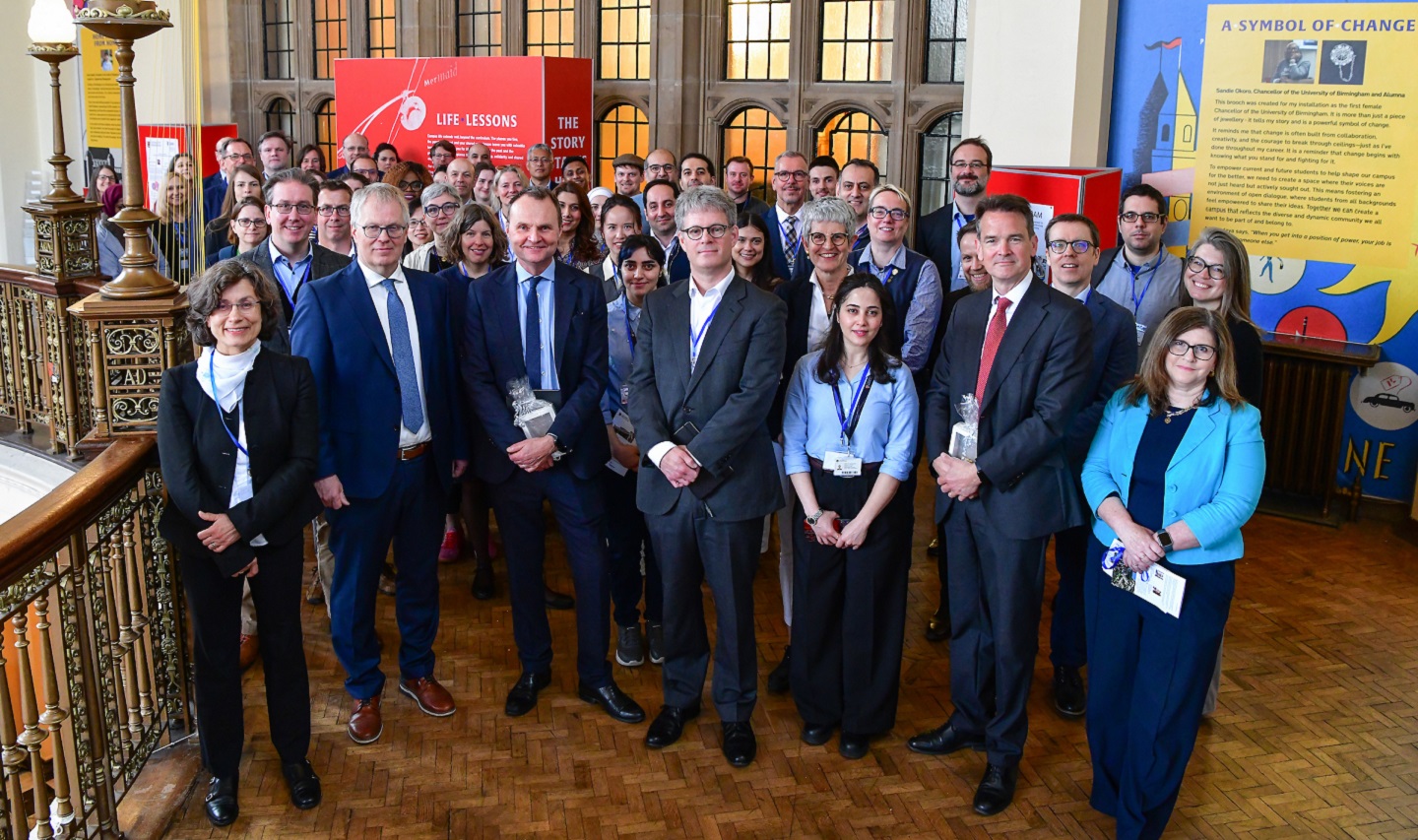 A group of UoB staff and BAM visitors standing in mezzanine area of Aston Webb