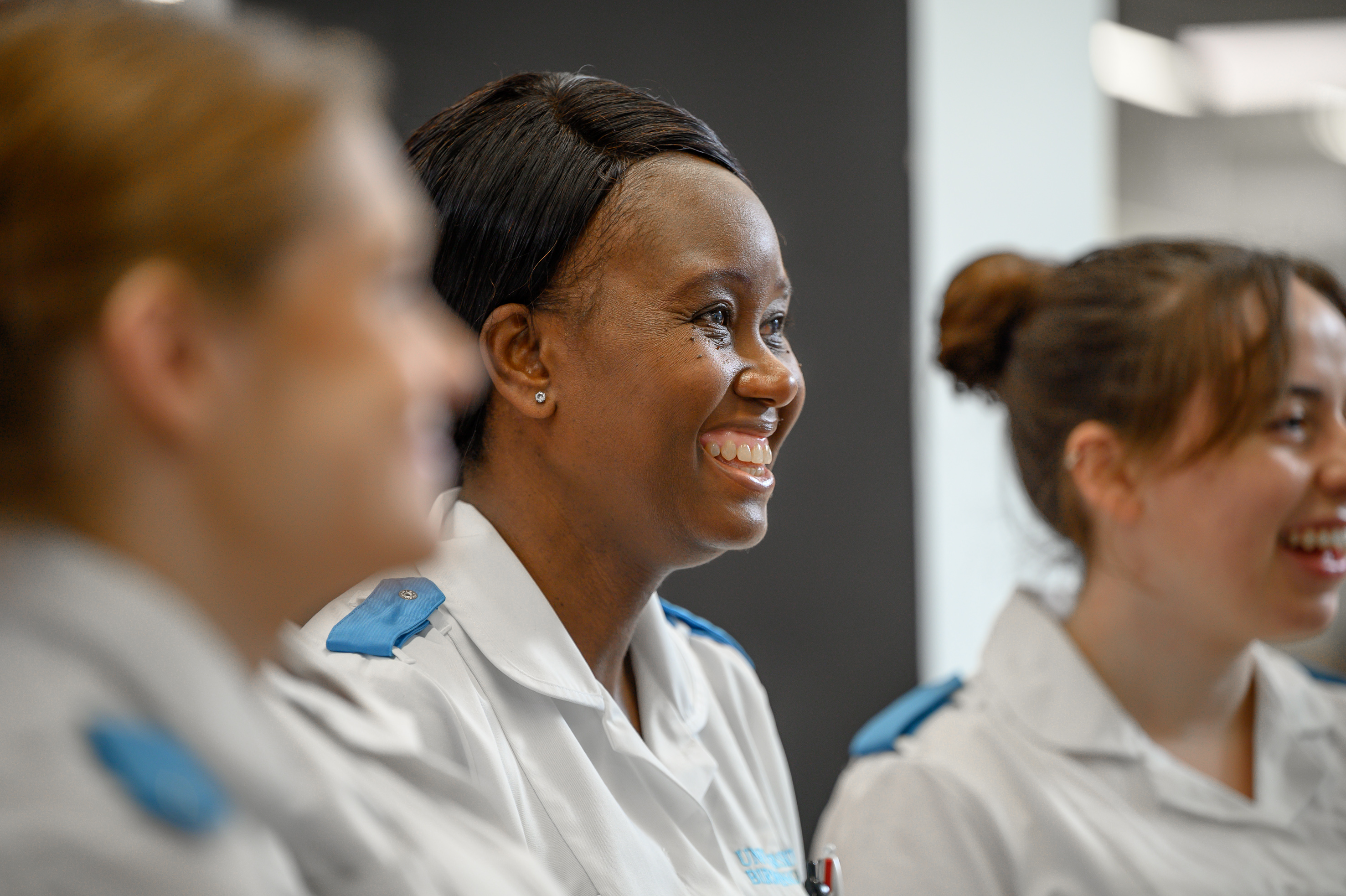 Three students laughing in medical uniform