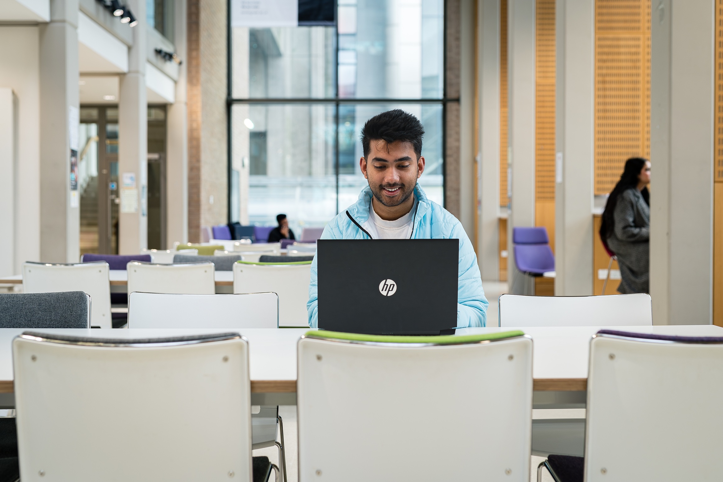 A student working on a laptop in a study space