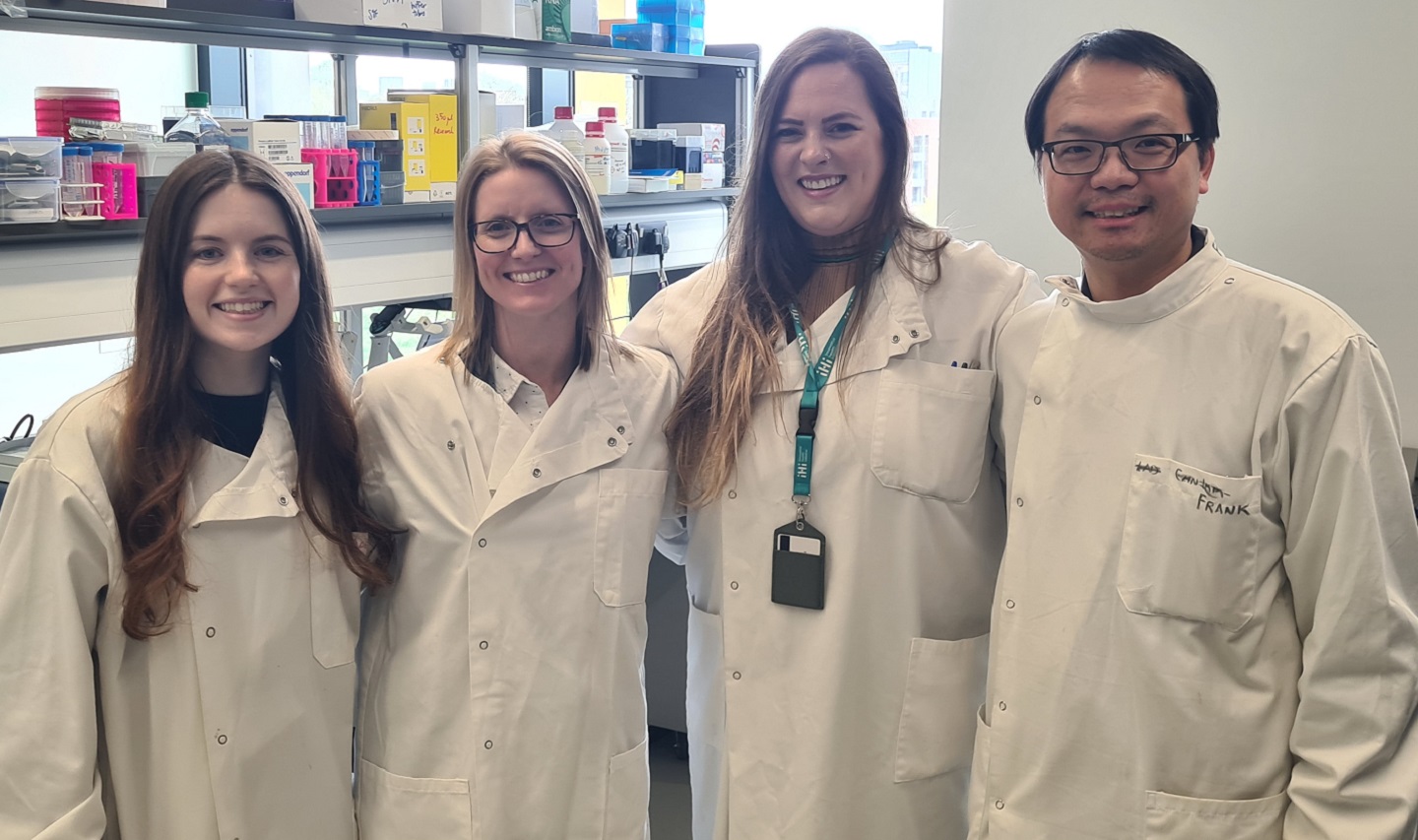 Four scientist in lab coats in a laboratory