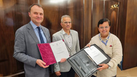 Professor Adam Tickell, Vikas Rastogi, and Dr Shailendra Deolankar holding the signed a Memorandum of Understanding