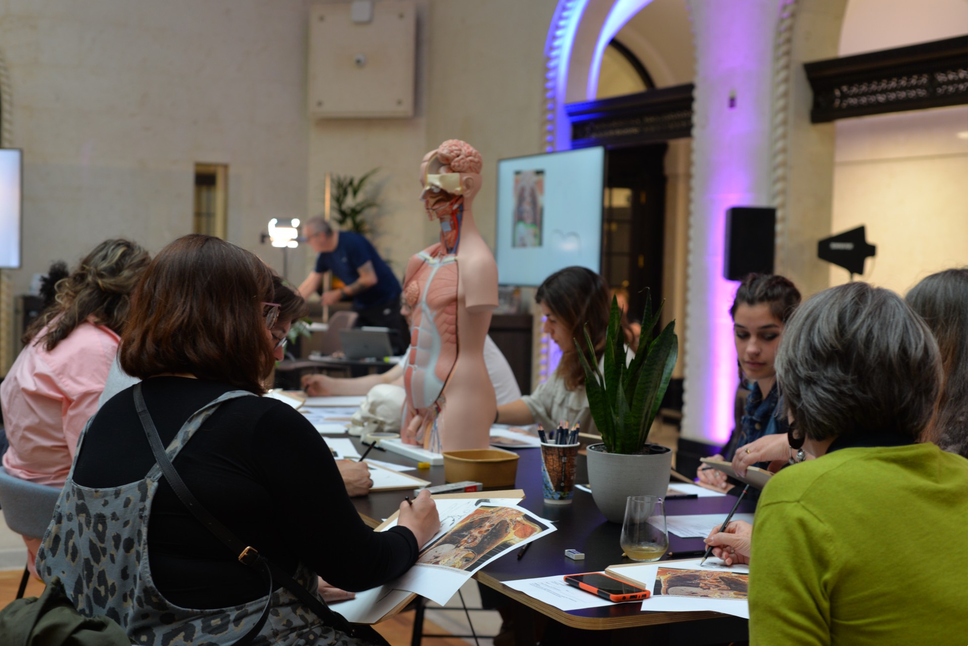 Community group taking part in anatomy drawing workshop