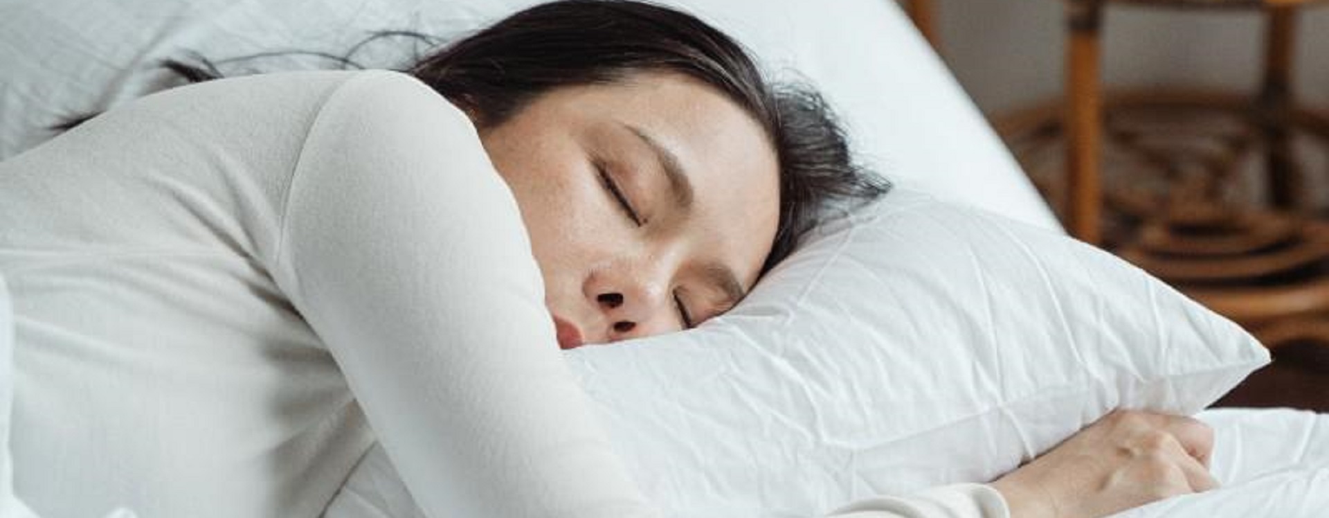 Woman wearing white top sleeping