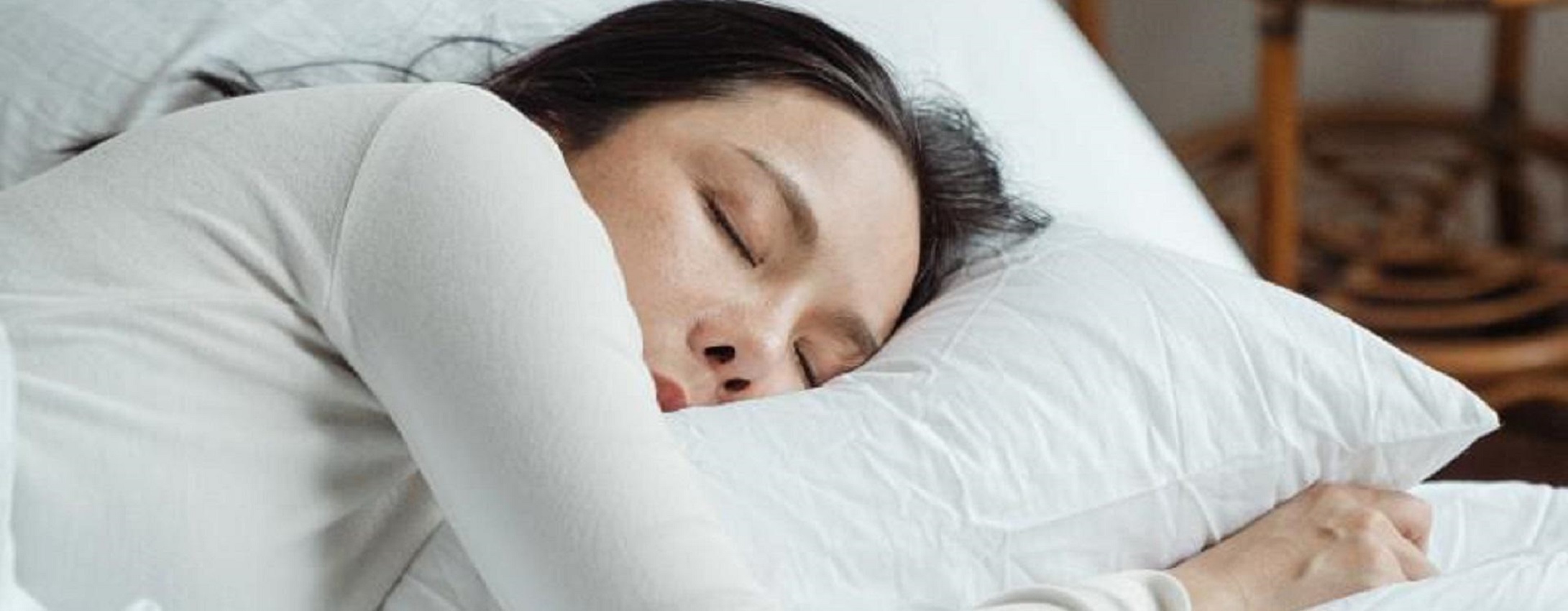 A woman asleep in a bed