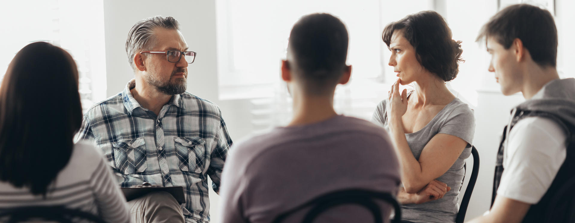  Woman Talking To Professional Psychotherapist In Support Group