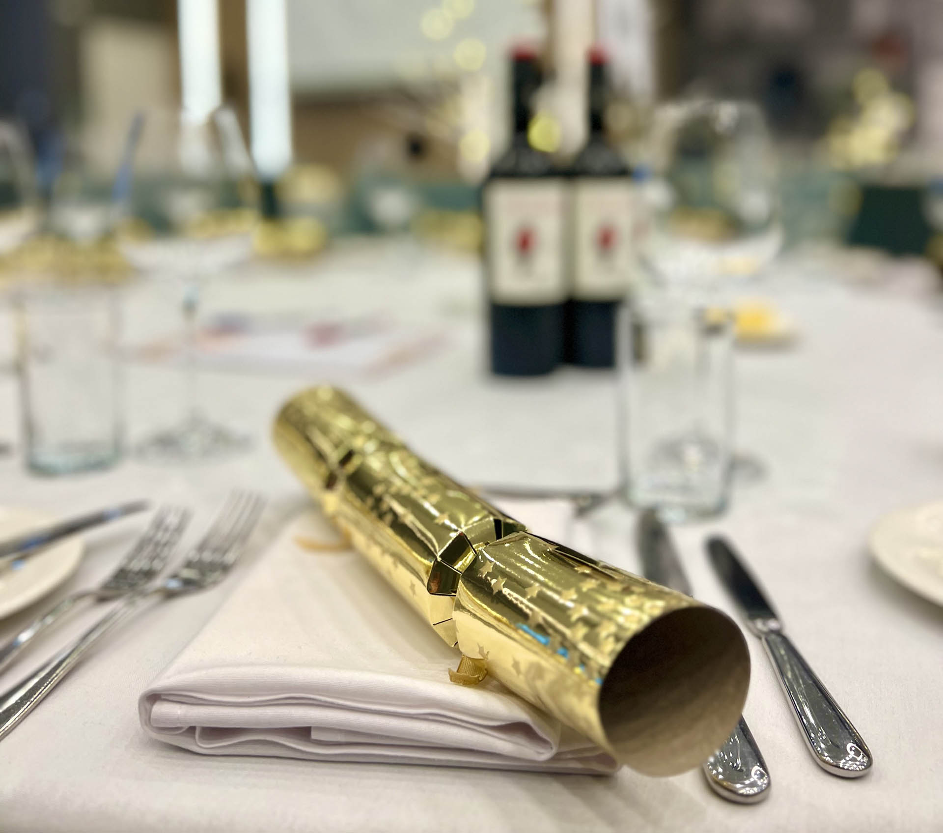 A Christmas Cracker on a table laid up for a meal