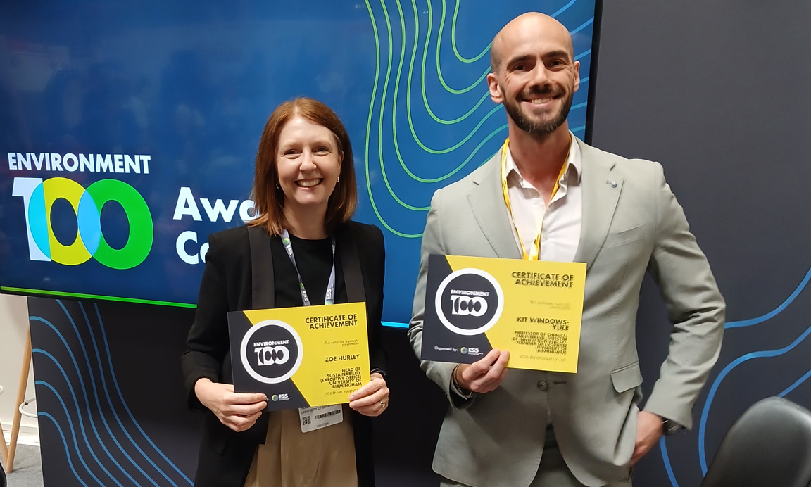 Zoe Hurley and Kit Windows-Yule are stood in front of a screen that says Environment 100, holding certificates