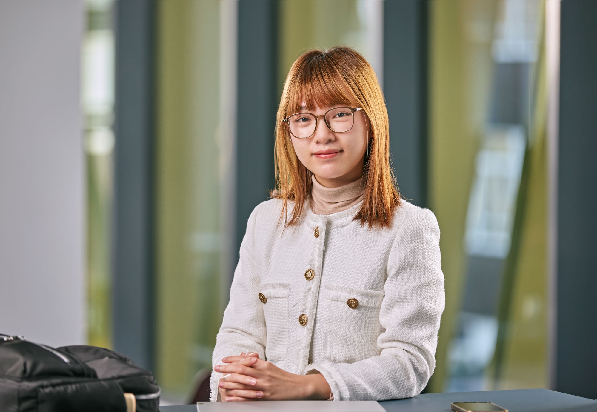 University of Birmingham alumnus, Hoang Le, wearing glasses and a white jacket