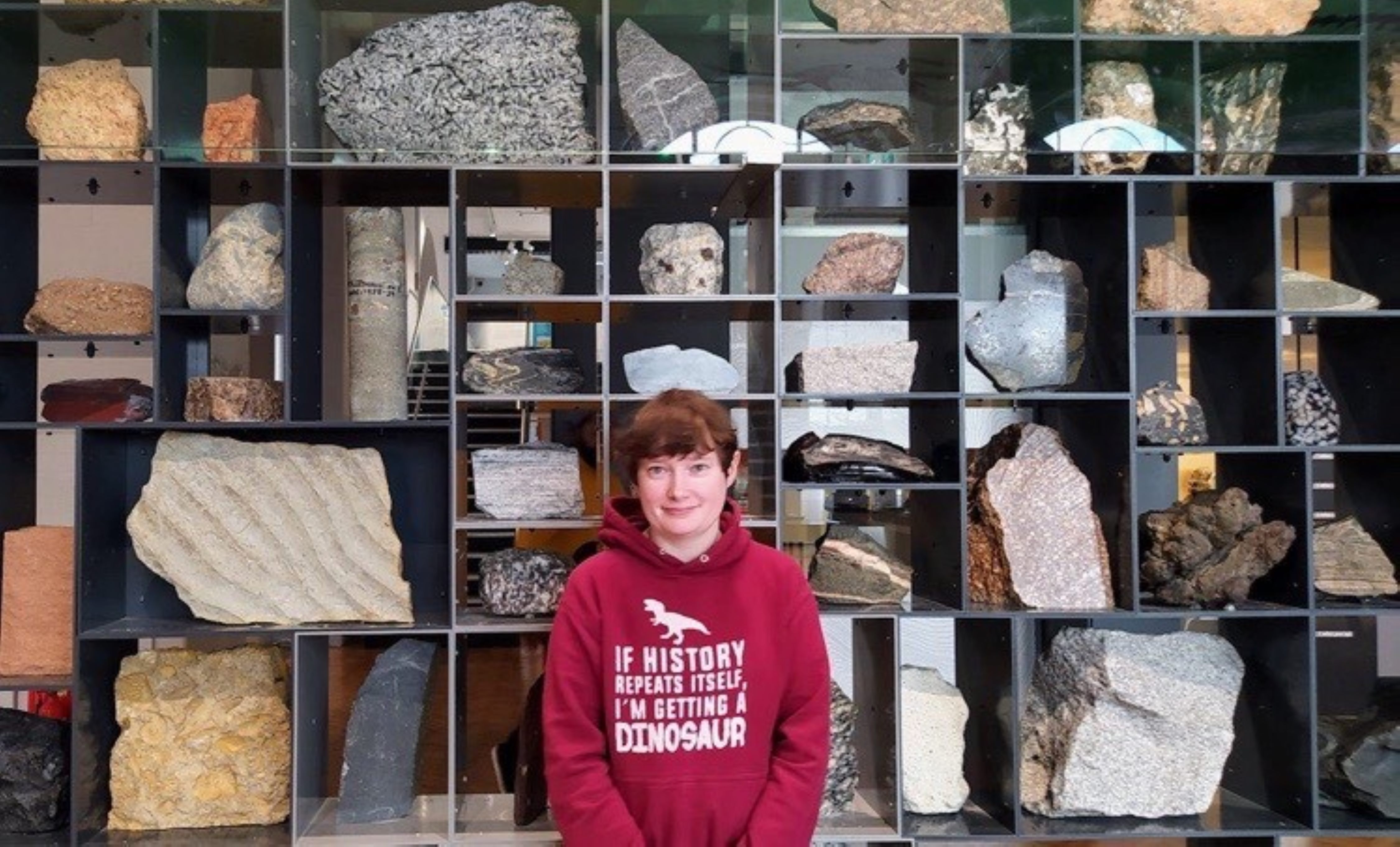 Amalia standing in front of the Rock Wall at the Lapworth Museum of Geology.