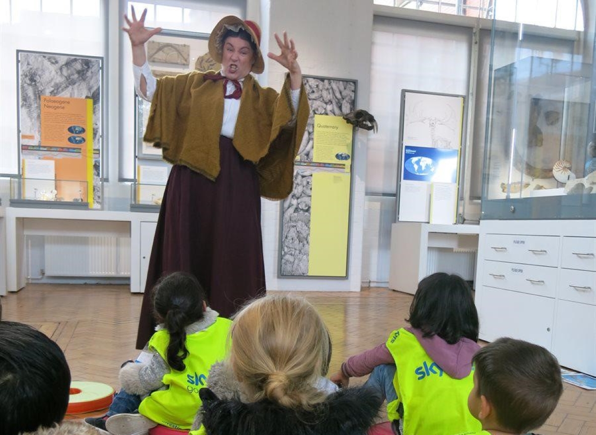 An actor portrays Mary Anning with nursery children.