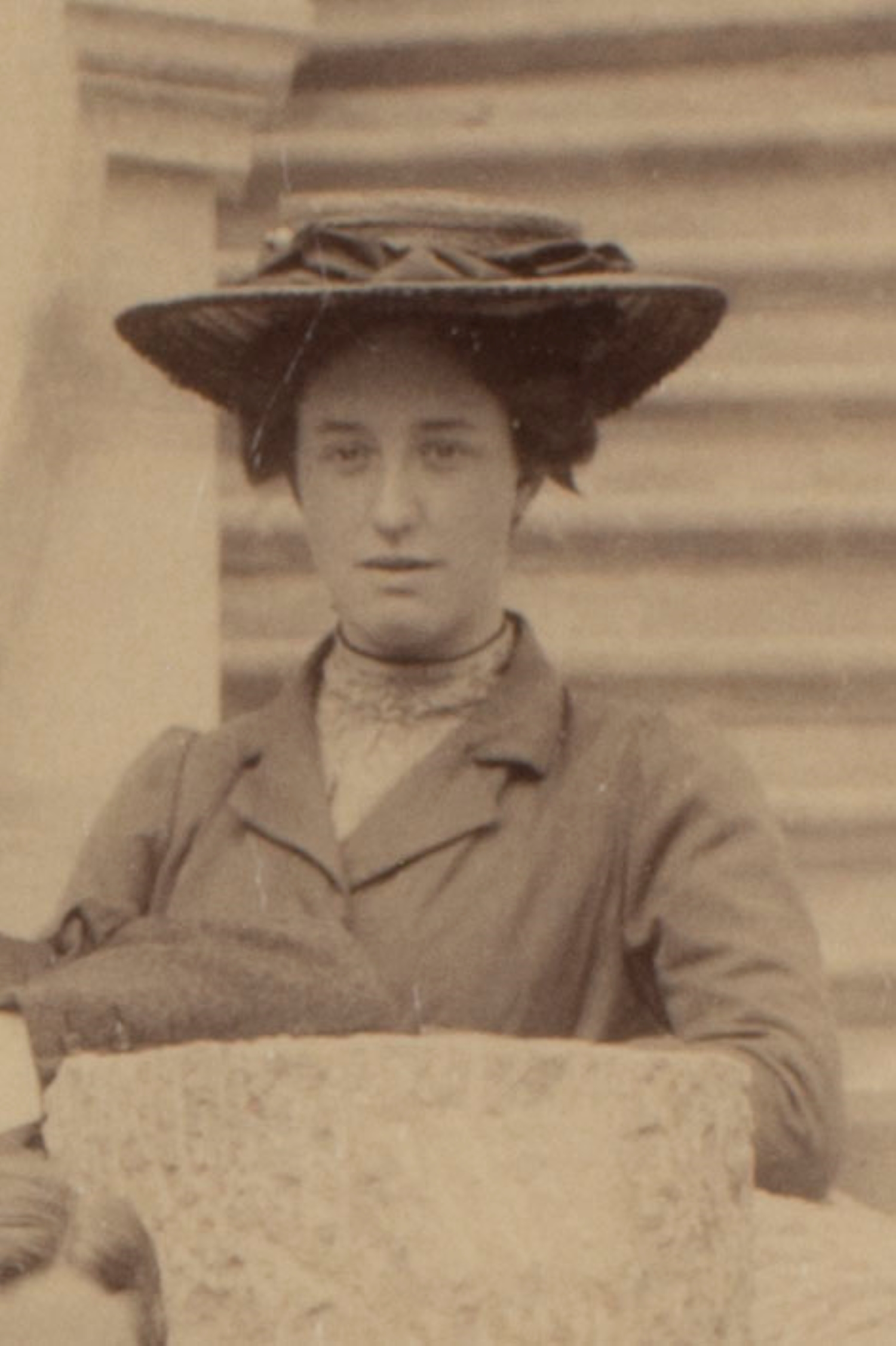 A sepia toned photograph of Ida Slater in a large, Victorian hat.