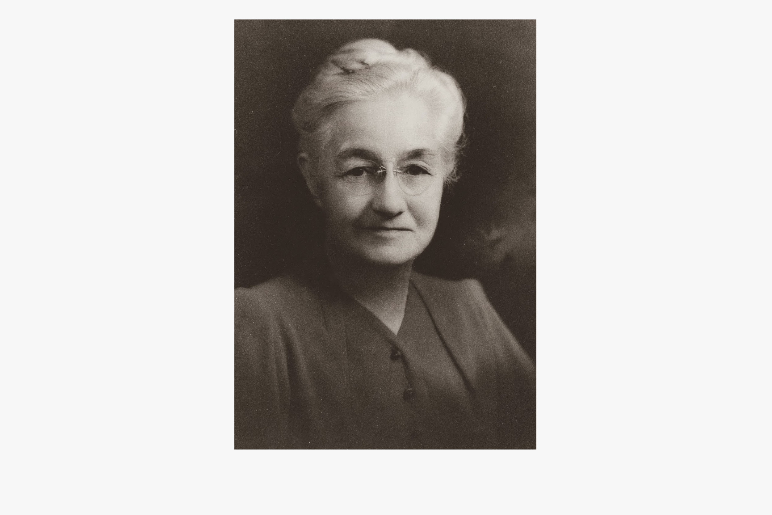 A black and white portrait of an elderly Mignon Talbot.