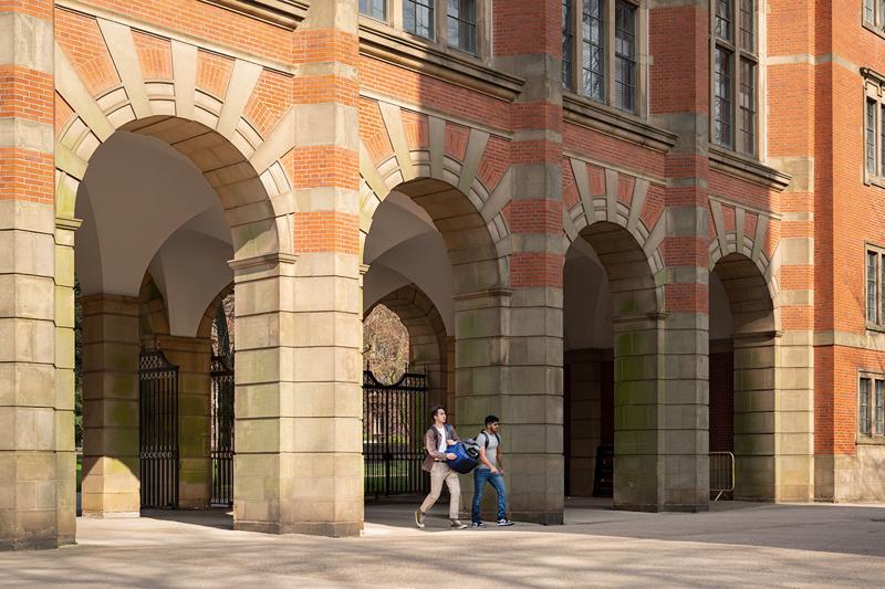 students walking through the Law Building arches at the University of Birmingham