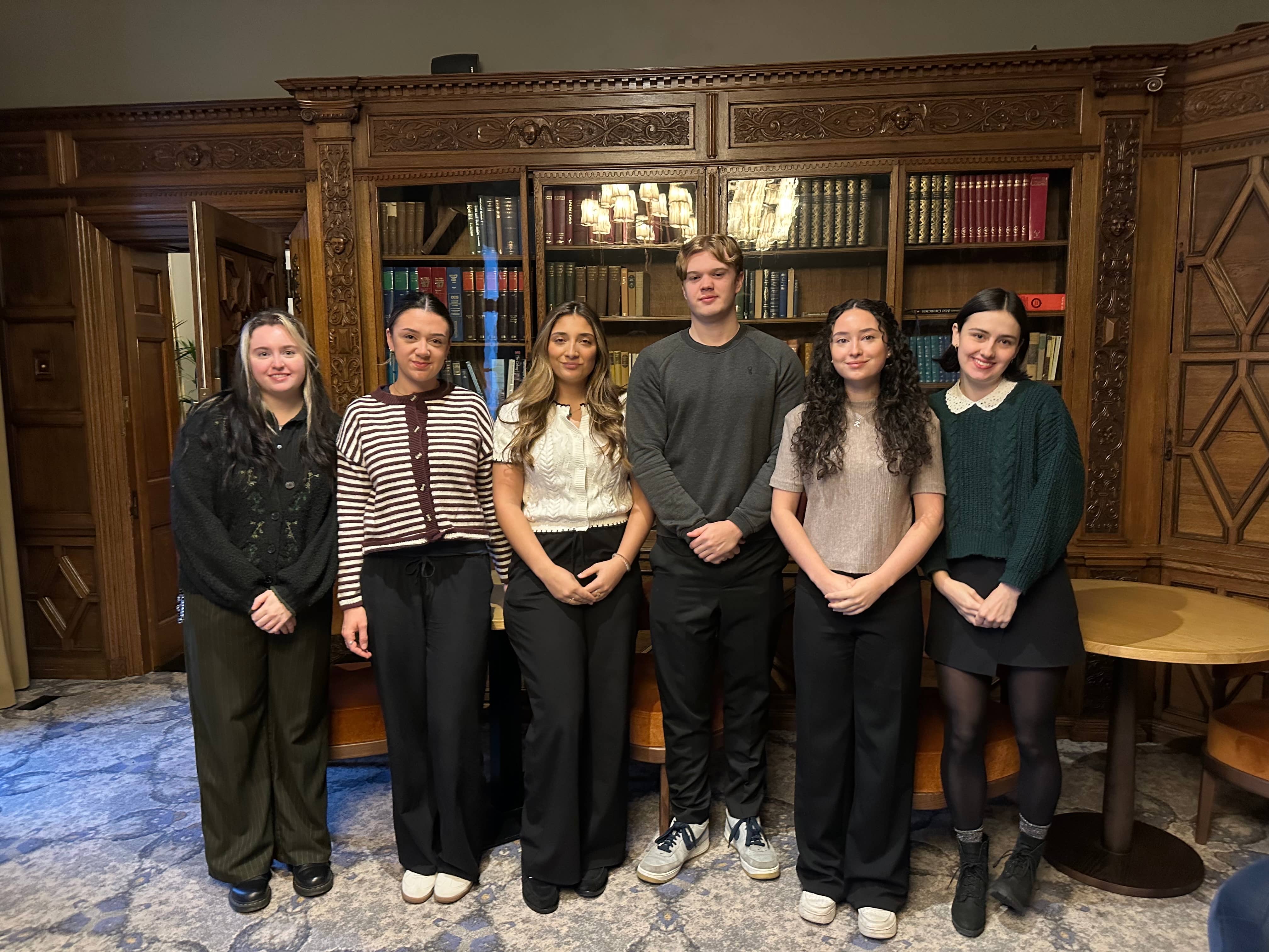 Group picture of CERJ-PARC cohort standing in front of a bookcase.