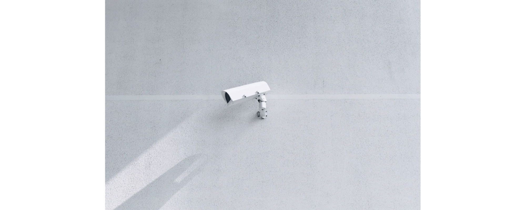 Security camera on a concrete wall.