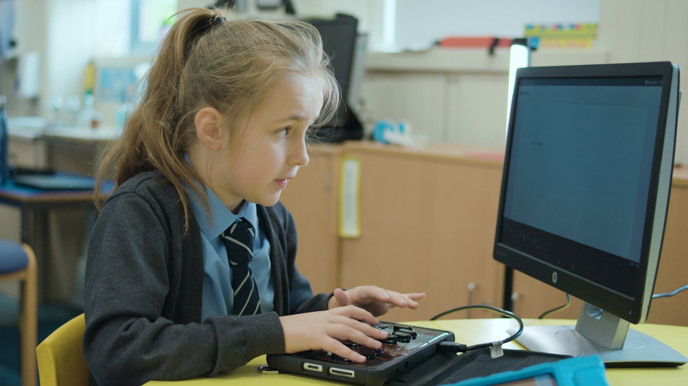 A pupil with vision impairment using a computer