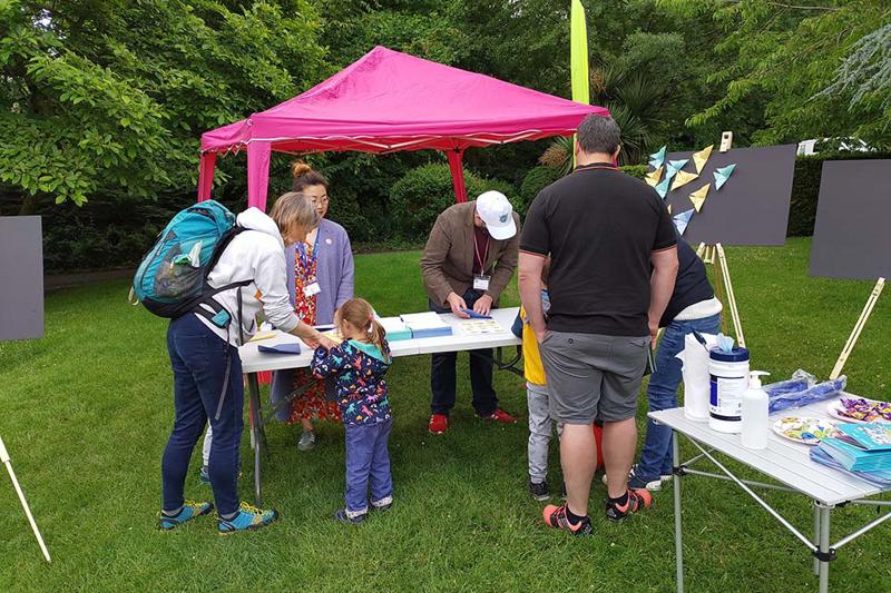 Members of the public taking part in a mathematics enagement activity at Malvern Science in the Park, in Great Malvern