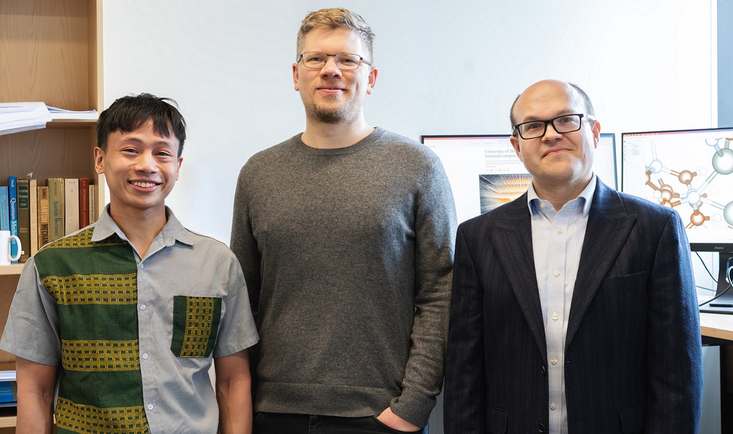 Three scientists standing in office