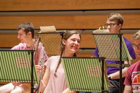 students smiling during a music performance