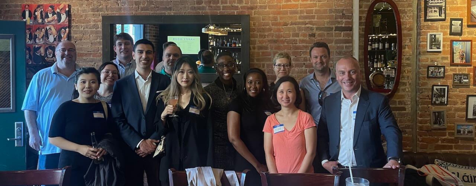 A group of people posing with drinks