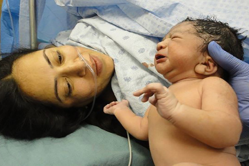 Newborn being held by mother minutes after arrival