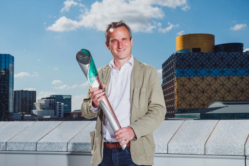 Professor Francis Pope holding the Queen’s Baton