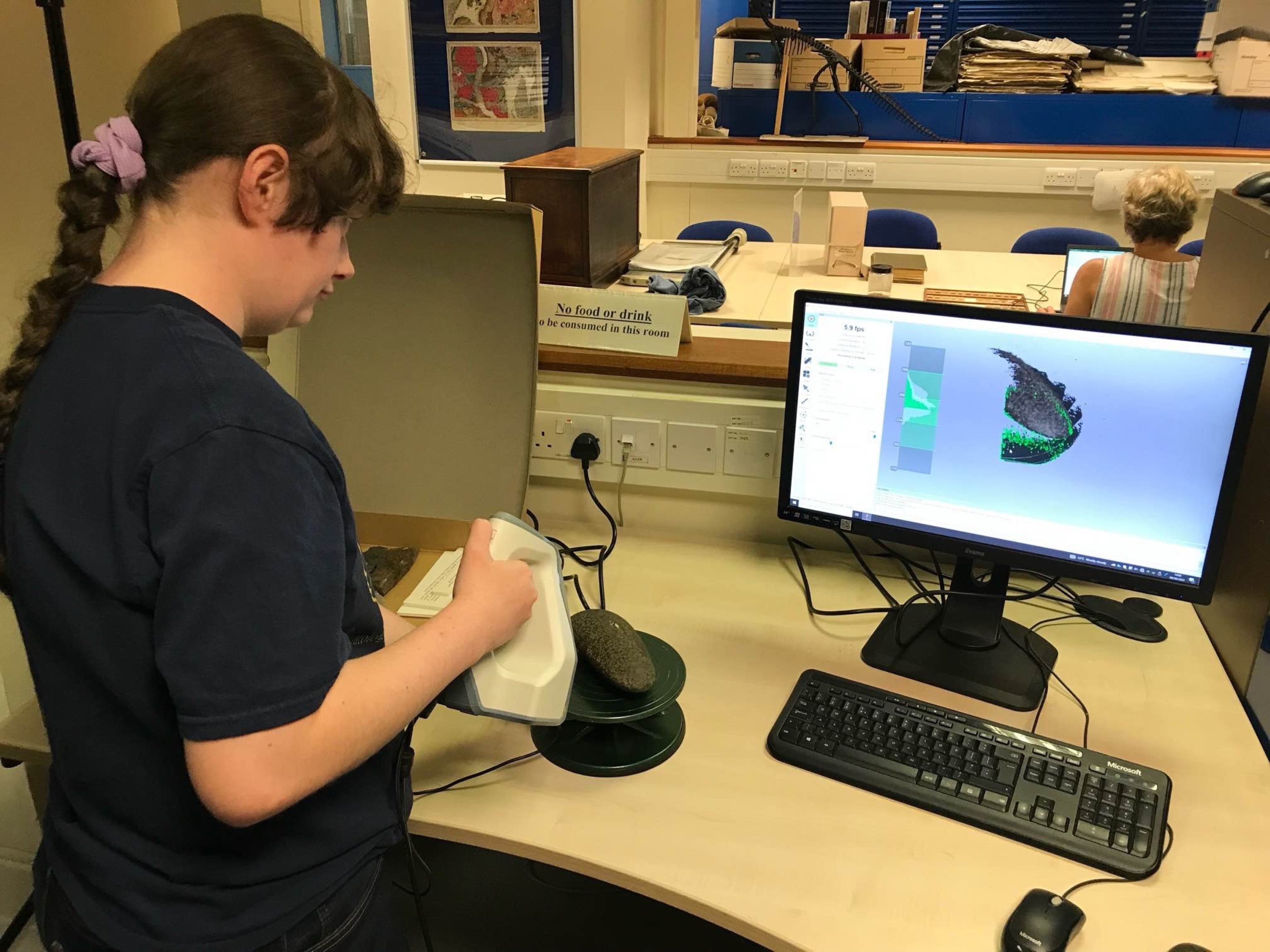 Amalia uses a 3D scanner to digitise a stone axe specimen at the Lapworth Museum.