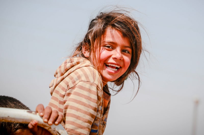 A young girl refugee with a cheerful smile