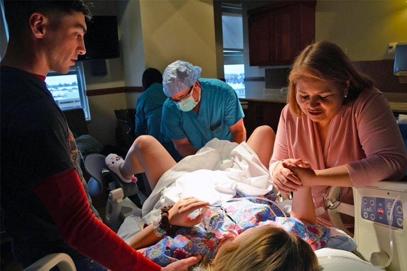 Intended parents attend the birth of their child by a gestational surrogate