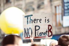 A protestor holding a sign saying "There is no Planet B"