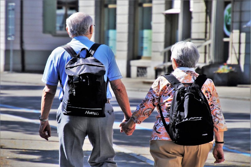 Pensioner couple walking hand in hand