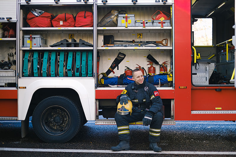 Fireman sitting in a truck looking tired