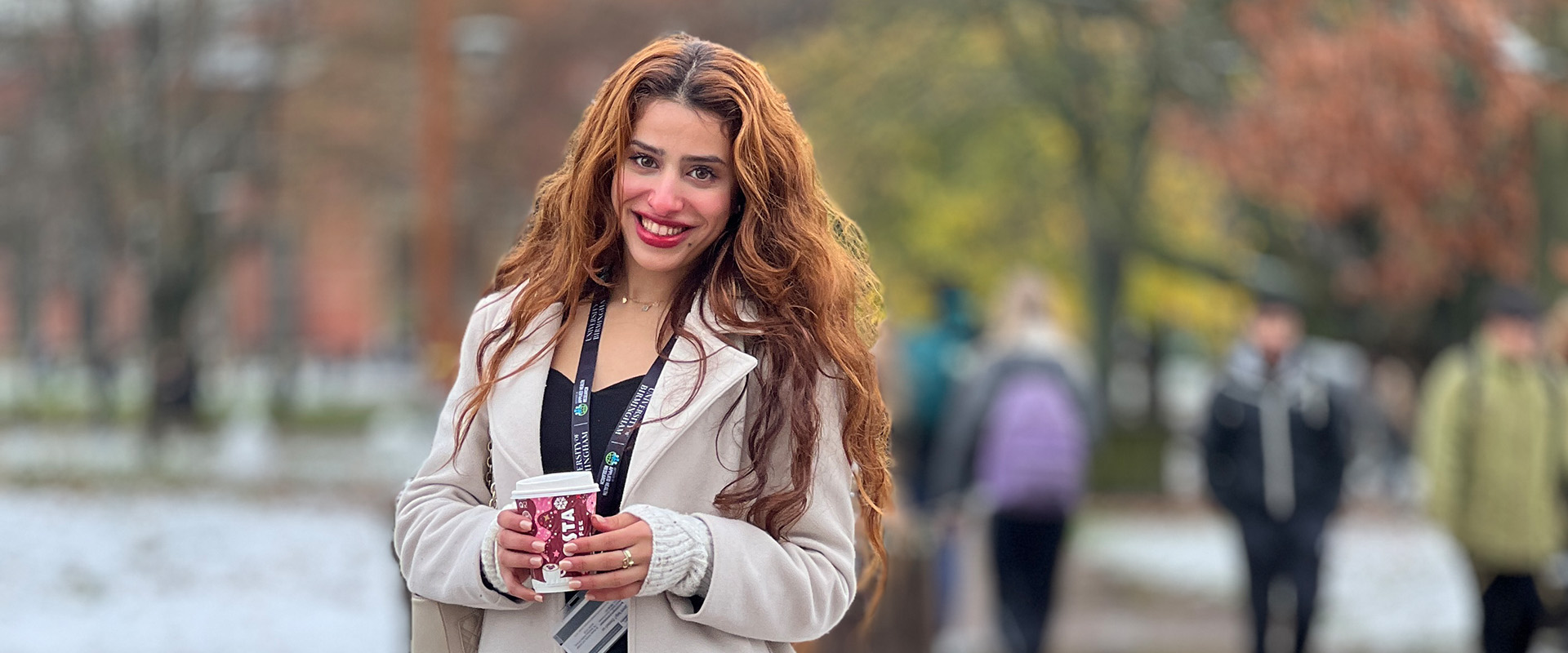 Asma Alghamdi holding a coffee cup