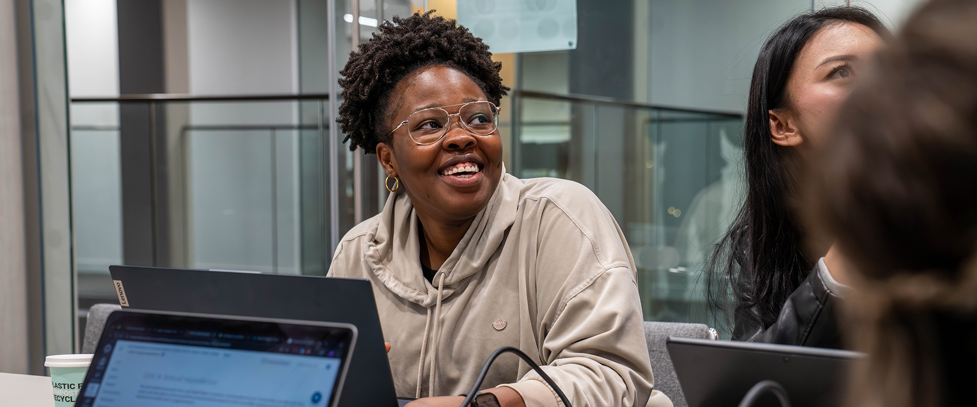 Student working on a laptop in a group study room
