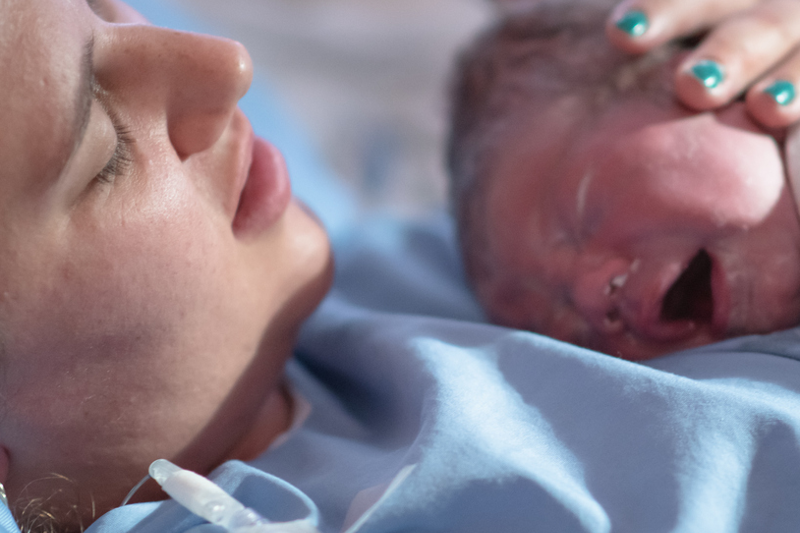 Newborn being held by mother minutes after arrival