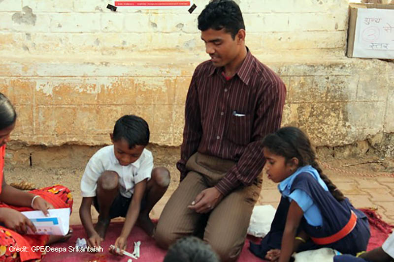 Two children being schooled in India