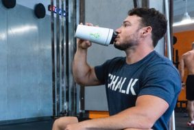Man drinking protein shake in a gym