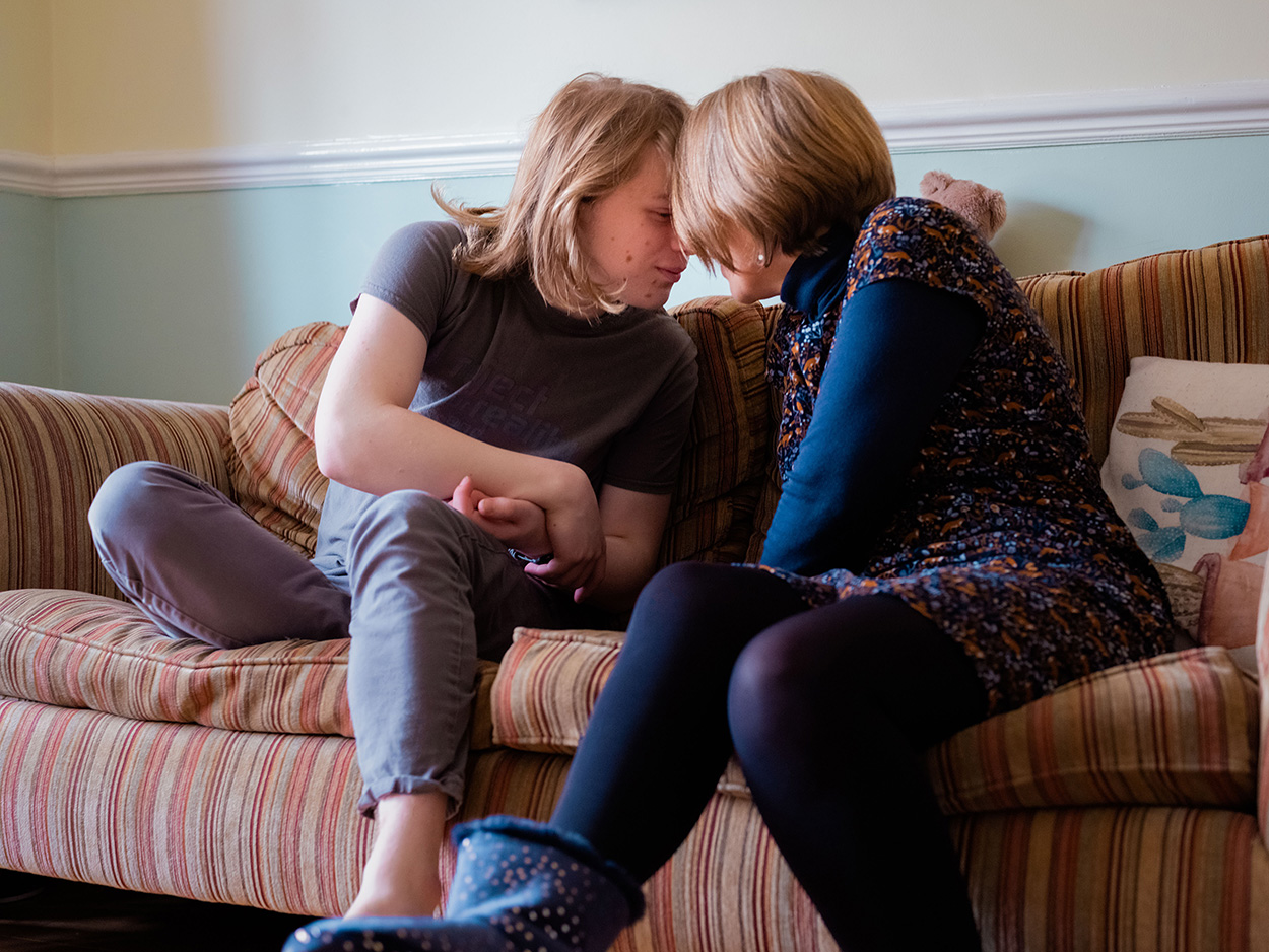 A young man and a woman touch foreheads